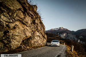 Tesla Model 3 – front three-quarter, white on a mountain road