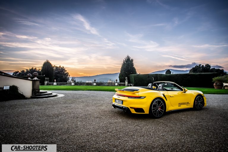 Porsche 911 Turbo Cabrio &ndash; rear three-quarter, yellow against a mountain backdrop