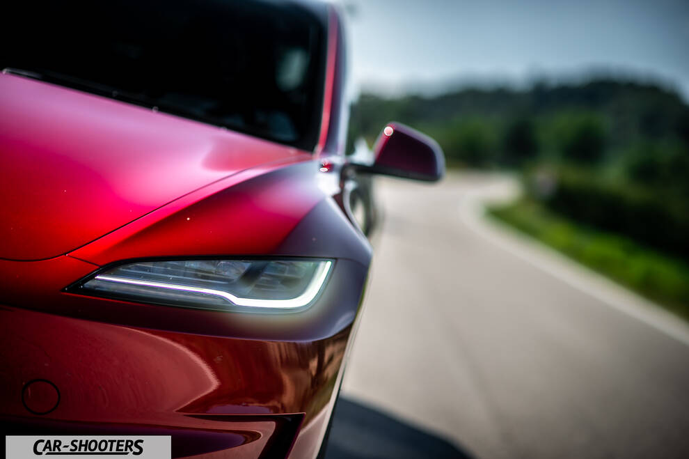 Tesla Model 3 Performance – front three-quarter, red on a country road